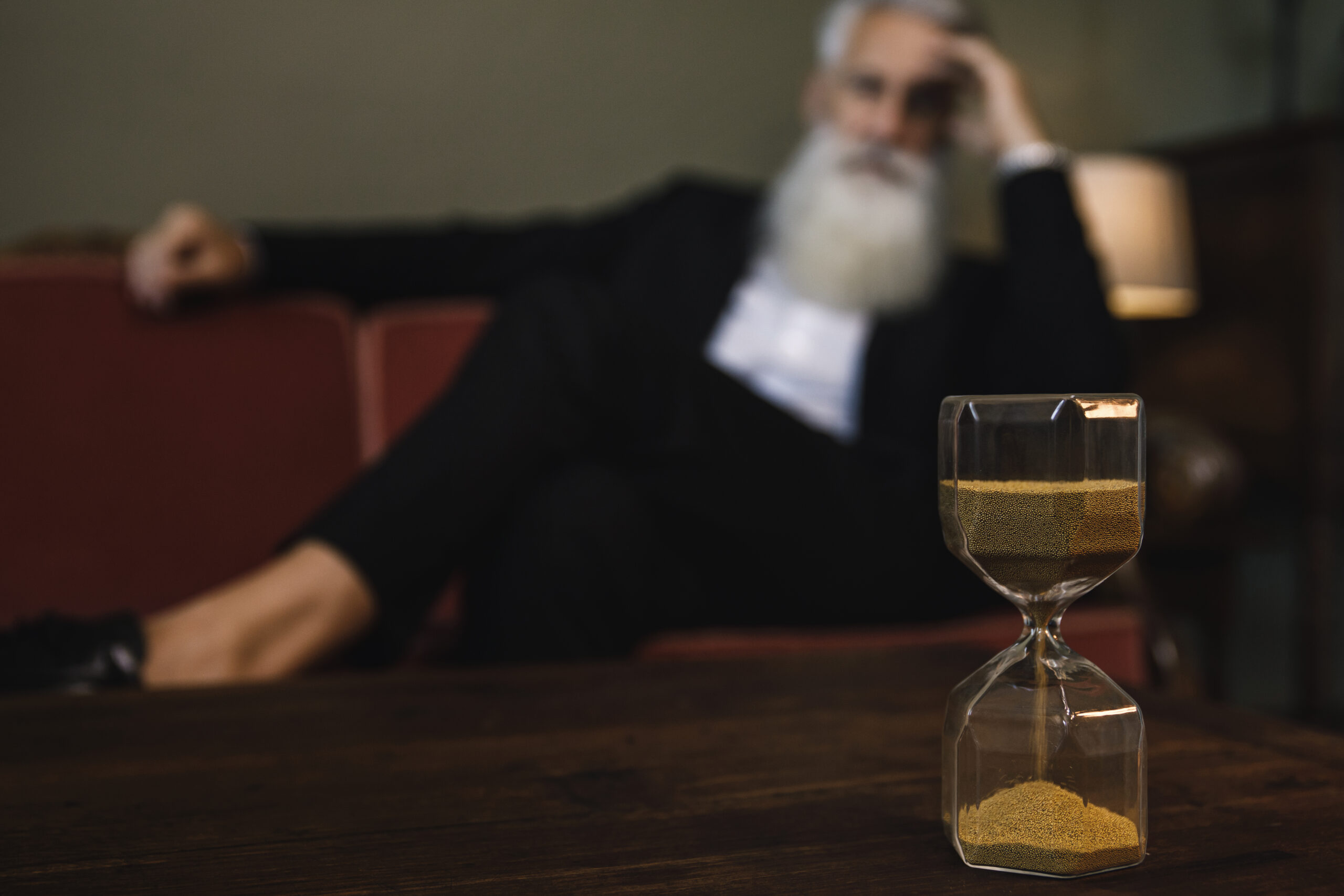 Senior man looking on the hourglass. Time and life. How Much Does Drug and Alcohol Rehab Cost in Ontario, Canada?