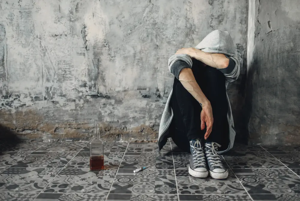 druggy-sitting-on-the-floor-withdrawal-symptom-2023-11-27-05-07-35-utc Is Cocaine Addictive? Insights from a Cocaine Rehab Guide