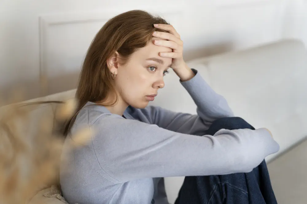 anxious-woman-sitting-couch-side-view Alcohol Abuse Addiction Recognizing and Recovering Strategies