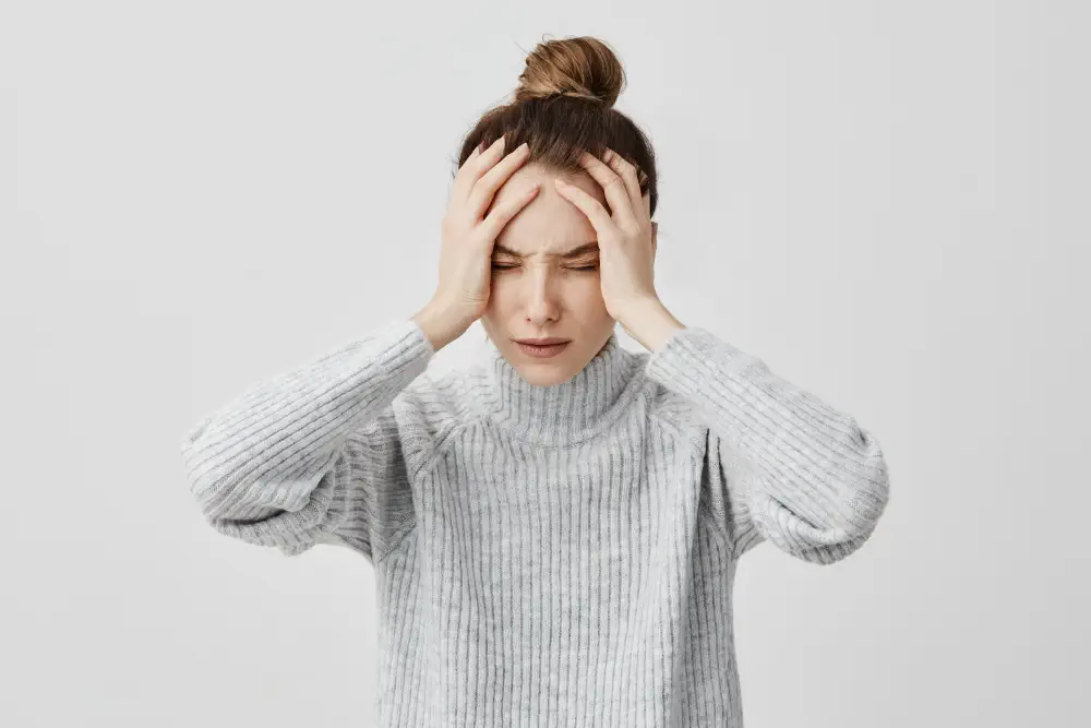 exhausted-young-woman-touching-her-head-with-eyes-closed-female-exchange-worker-suffering-from-unbearable-headache-health-concept How Quickly Does Bipolar Disorder Get Worse Without Treatment?