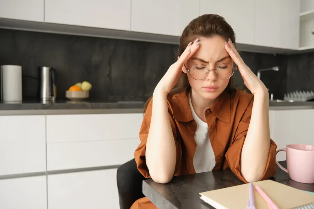 portrait-tired-young-working-woman-glasses-holds-hands-head-suffers-painful-migraine-has What are the Most Effective Treatments for Adderall Addiction?