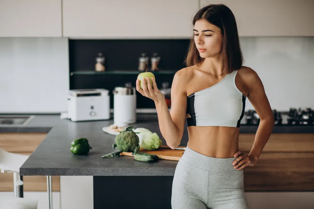 sporty-woman-with-apple-kitchen How to Detox from Weed: A Practical Guide