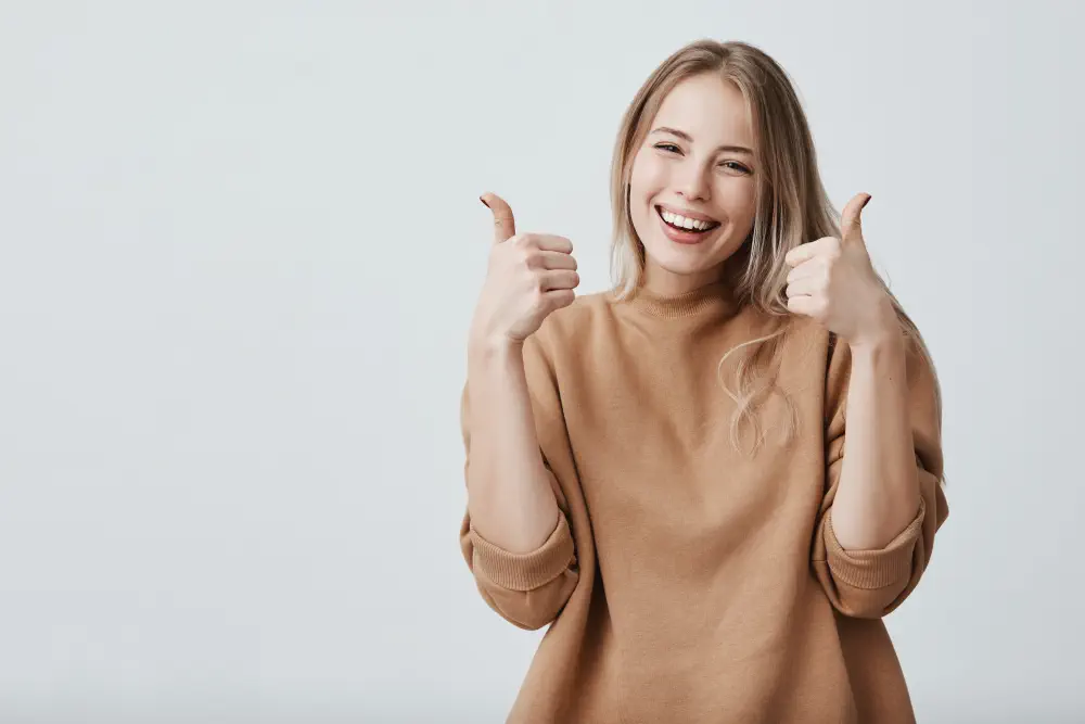 portrait-fair-haired-beautiful-female-woman-with-broad-smile-thumbs-up How to Help Someone with a Drinking Problem: A Guide