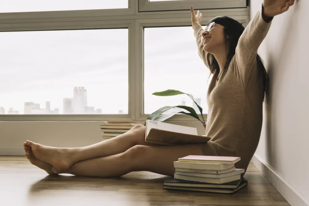 cheerful-woman-glasses-reading-floor What is the Treatment for Video Game Addiction?