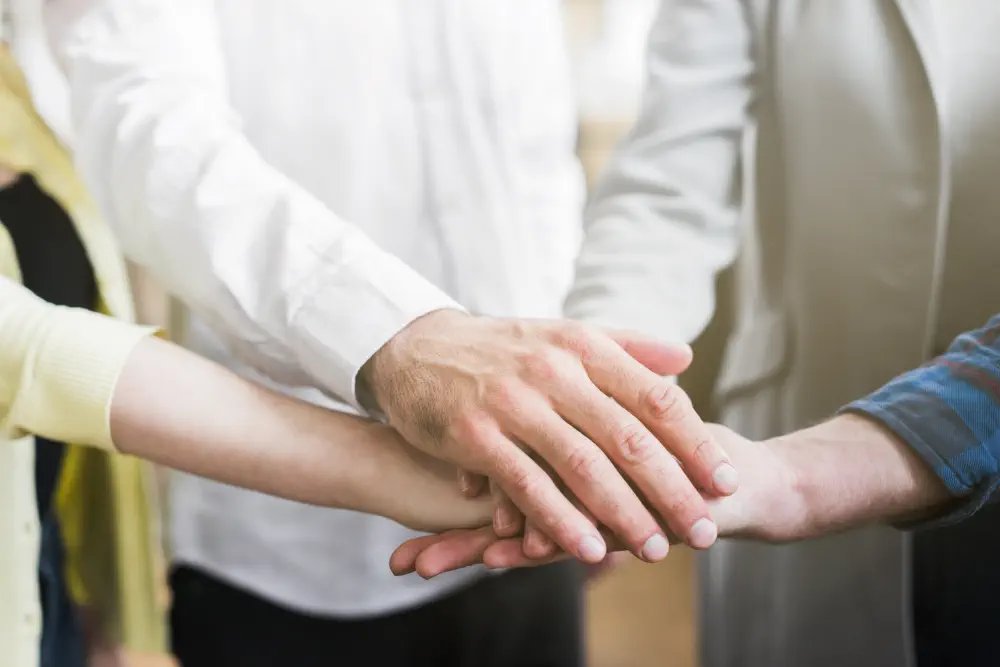 businesspeople-stacking-their-hands-showing-unity What Are the Symptoms of Drug-Induced Psychosis?