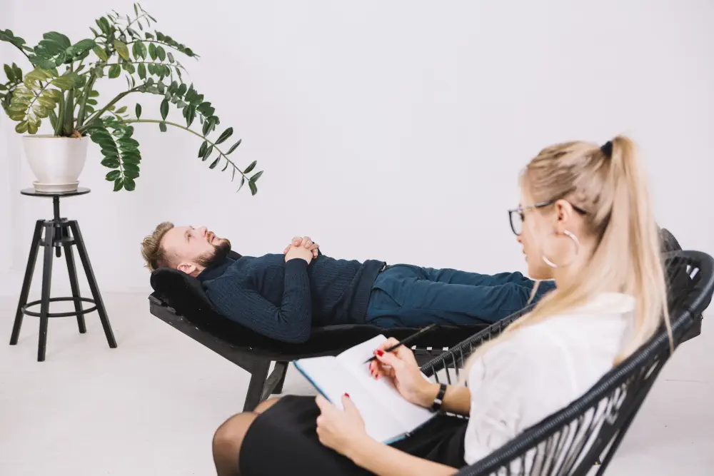 female-psychologist-writing-notes-diary-while-patient-lying-couch-clinic How to Help an ADDICT in 5 Easy Steps