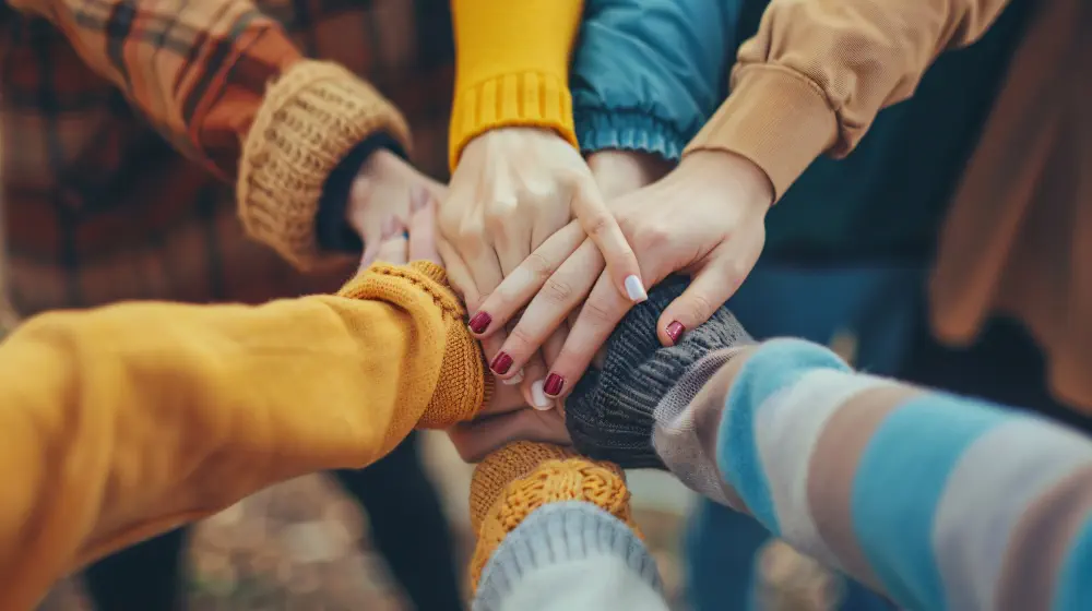 group-people-holding-hands-with-one-holding-cigarette Types of Best Rehab for Drug and Alcohol Treatment