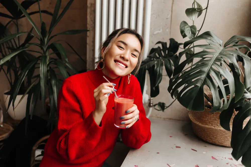 portrait-joyful-lady-red-oversized-sweater-holding-glass-freshly-squeezed-watermelon-juice-sitting-cafe-against-wall-plants What Are the Symptoms of Drug-Induced Psychosis?