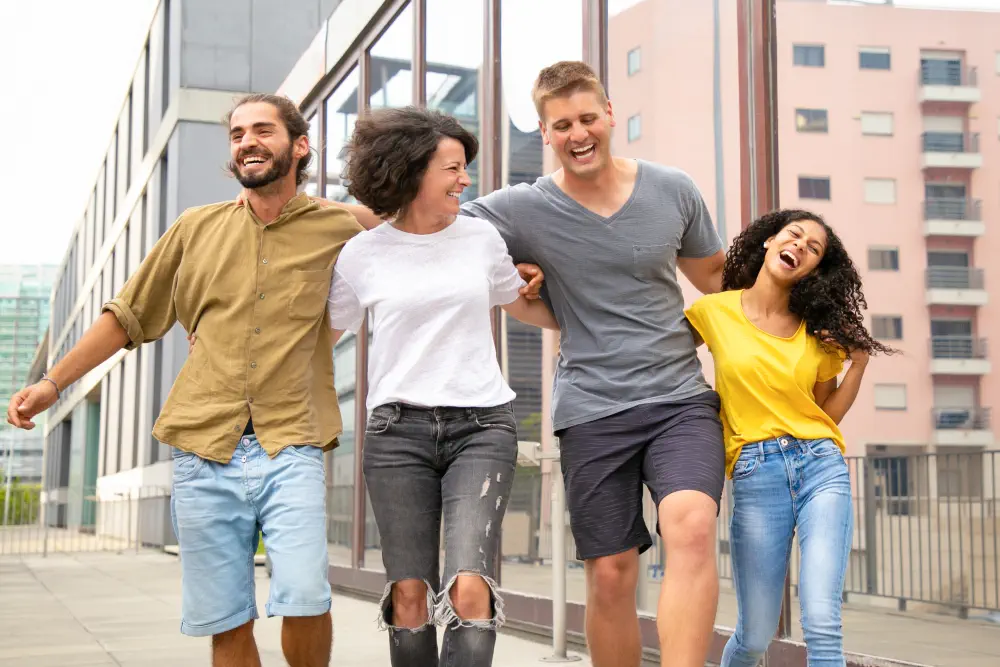 happy-carefree-friends-walking-outside-having-fun What Are the Risks of Being Codependent?
