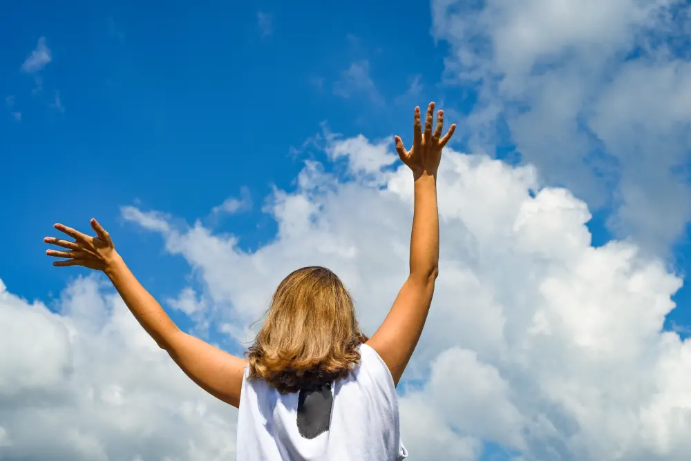 woman-girl-stands-stretches-her-hands-sky-girl-raised-her-hands-up-against-blue-sky How Does Gestalt Therapy Help With Addiction?