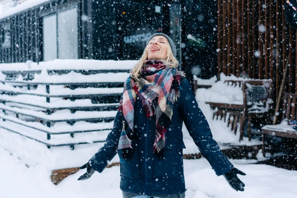 Woman catching snowflakes