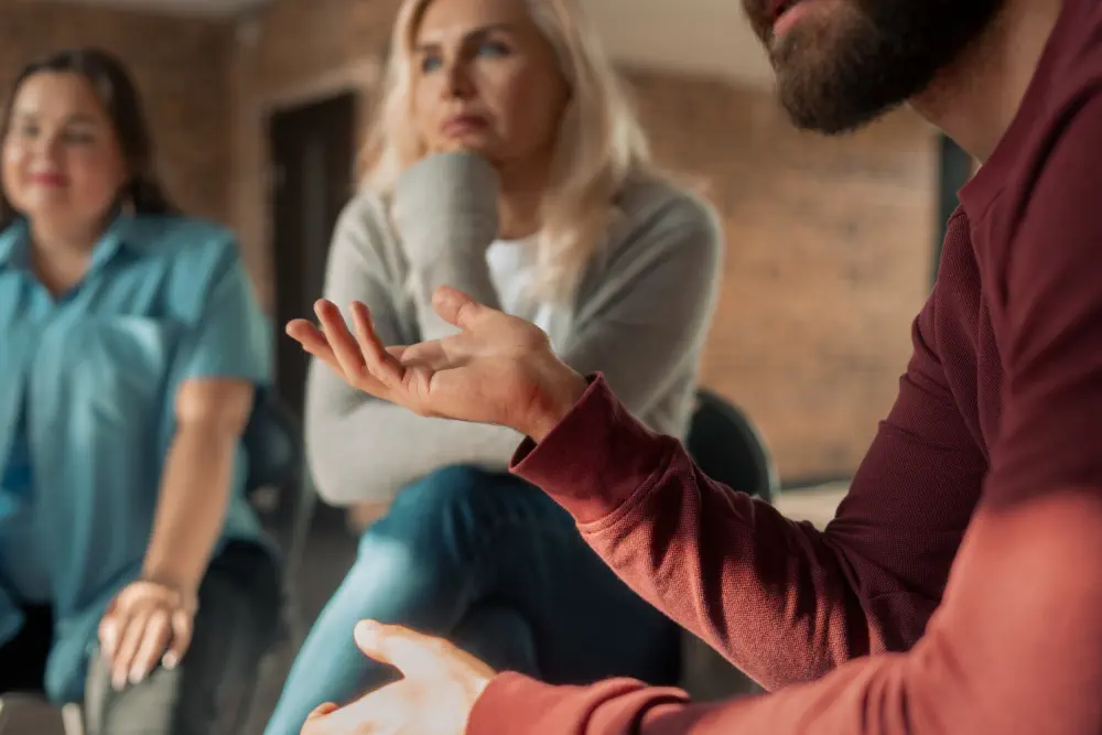 Person gesturing during a group session.